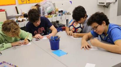 Middle School students work on their mosaic pieces